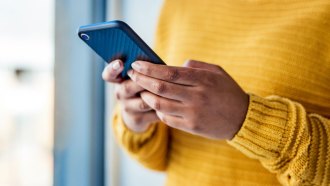 Close up of a woman holding a smartphone