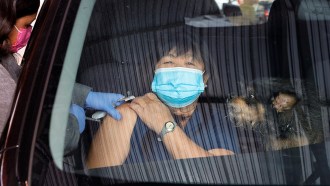 A woman receives a COVID shot at a pop-up vaccination clinic