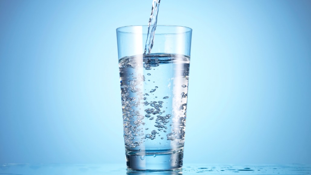 water being poured into a clear glass